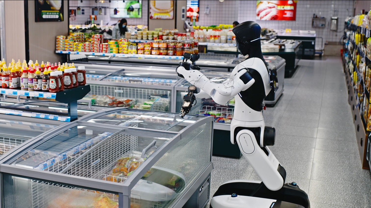 Theseus robot restocking a chilled cabinet in a supermarket